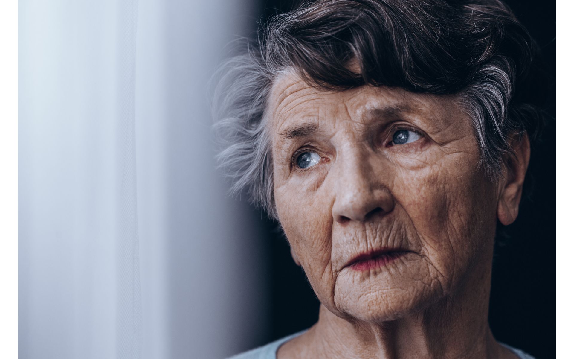 Woman looking sad. Article about 7 stages of grief in seniors.