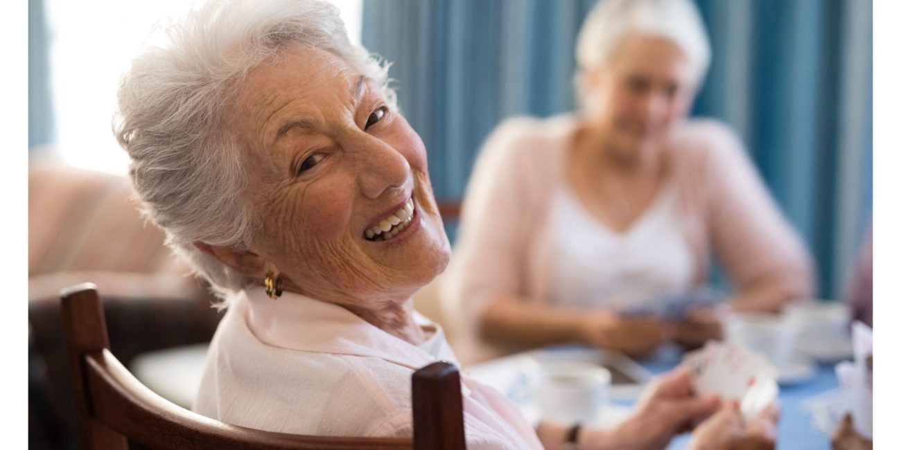 Older woman smiling at the camera.