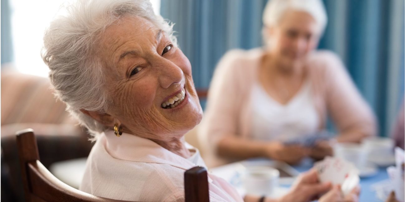Older woman smiling at the camera.