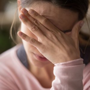 Woman is upset. Cover image for article about self-care for caretakers.