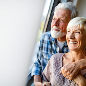 Older couple smiling. Cover image for article about smart home security.