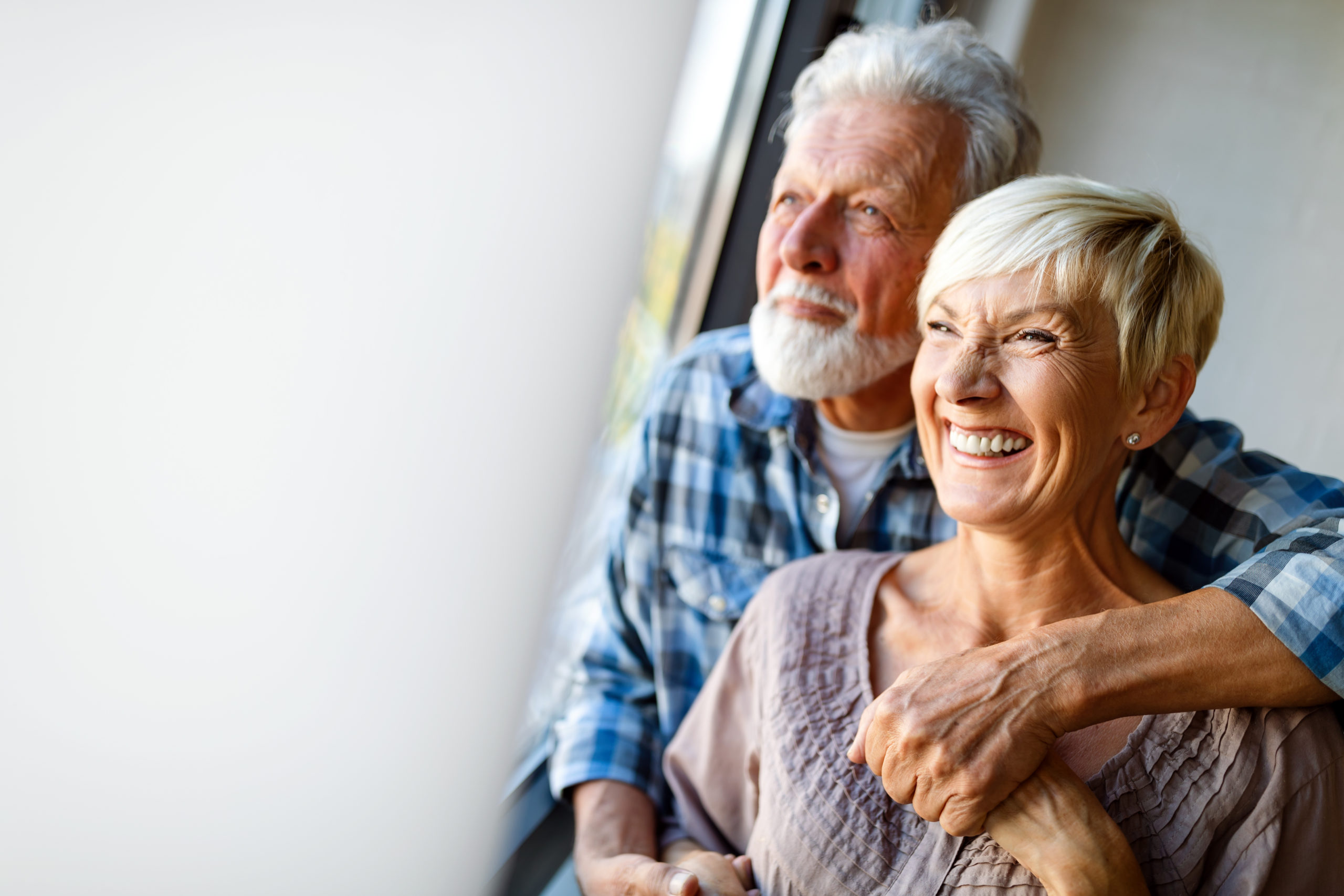 Older couple smiling. Cover image for article about smart home security.