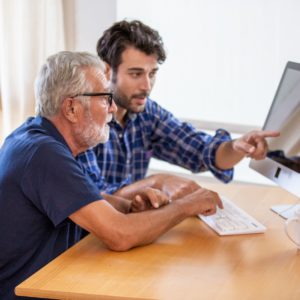 An elderly man and his son discuss internet findings.