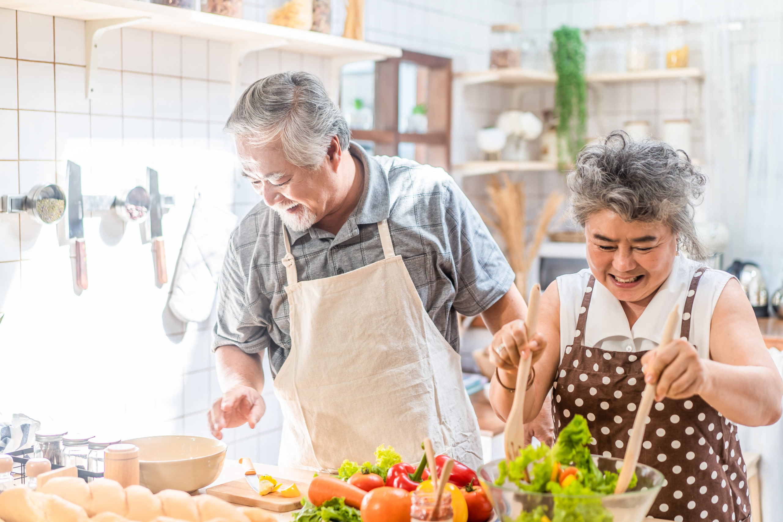 An older couple in the kitchen, highlighting adjustments for seniors.