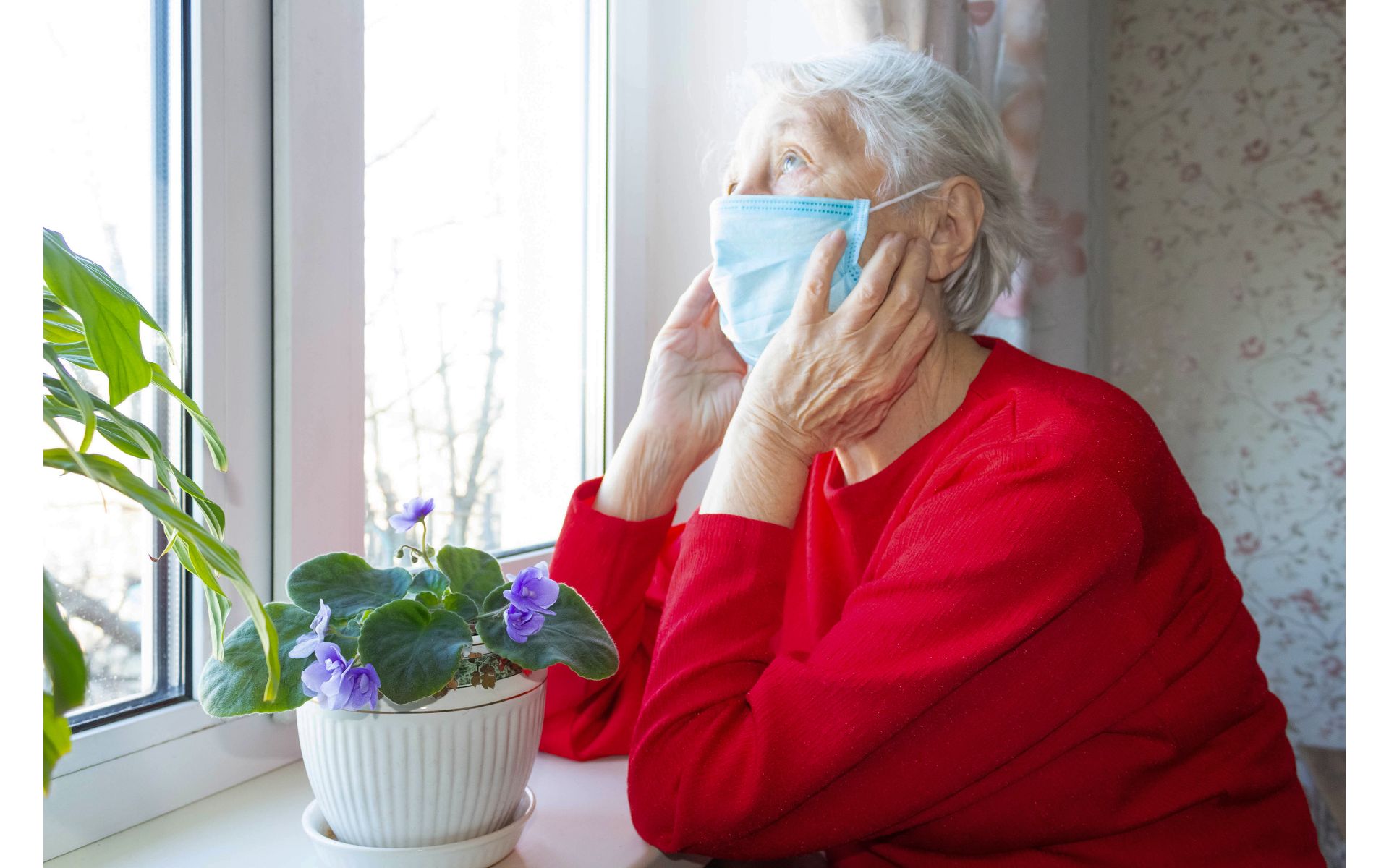 An older woman wearing a mask. Cover image for an article on keeping homes disease-free.
