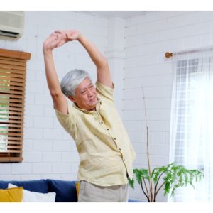 An older woman exercising at home.
