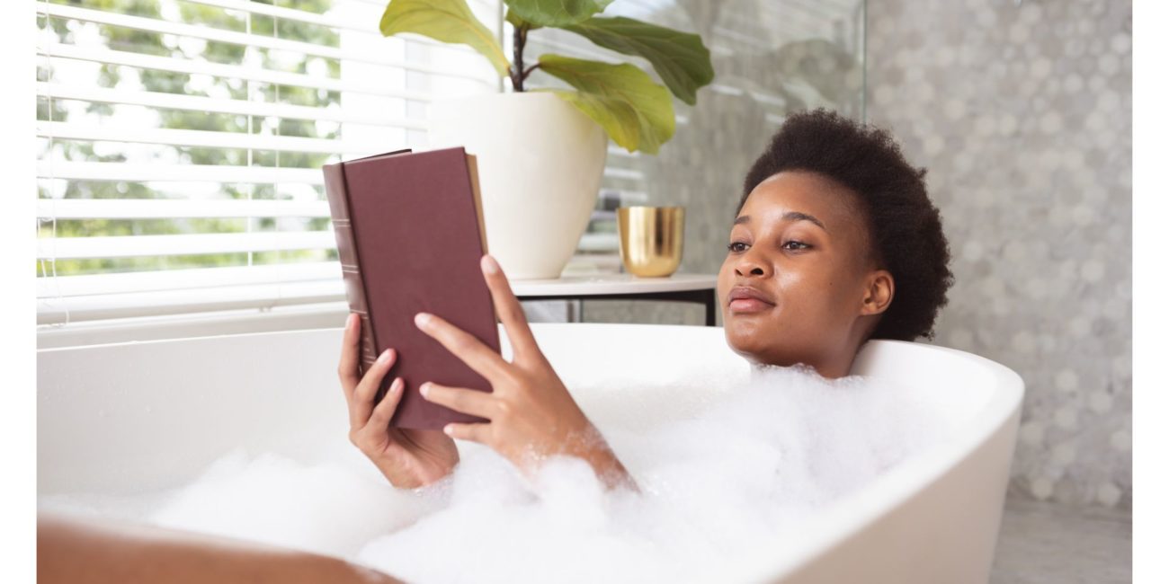 A woman relaxes in the bathtub.