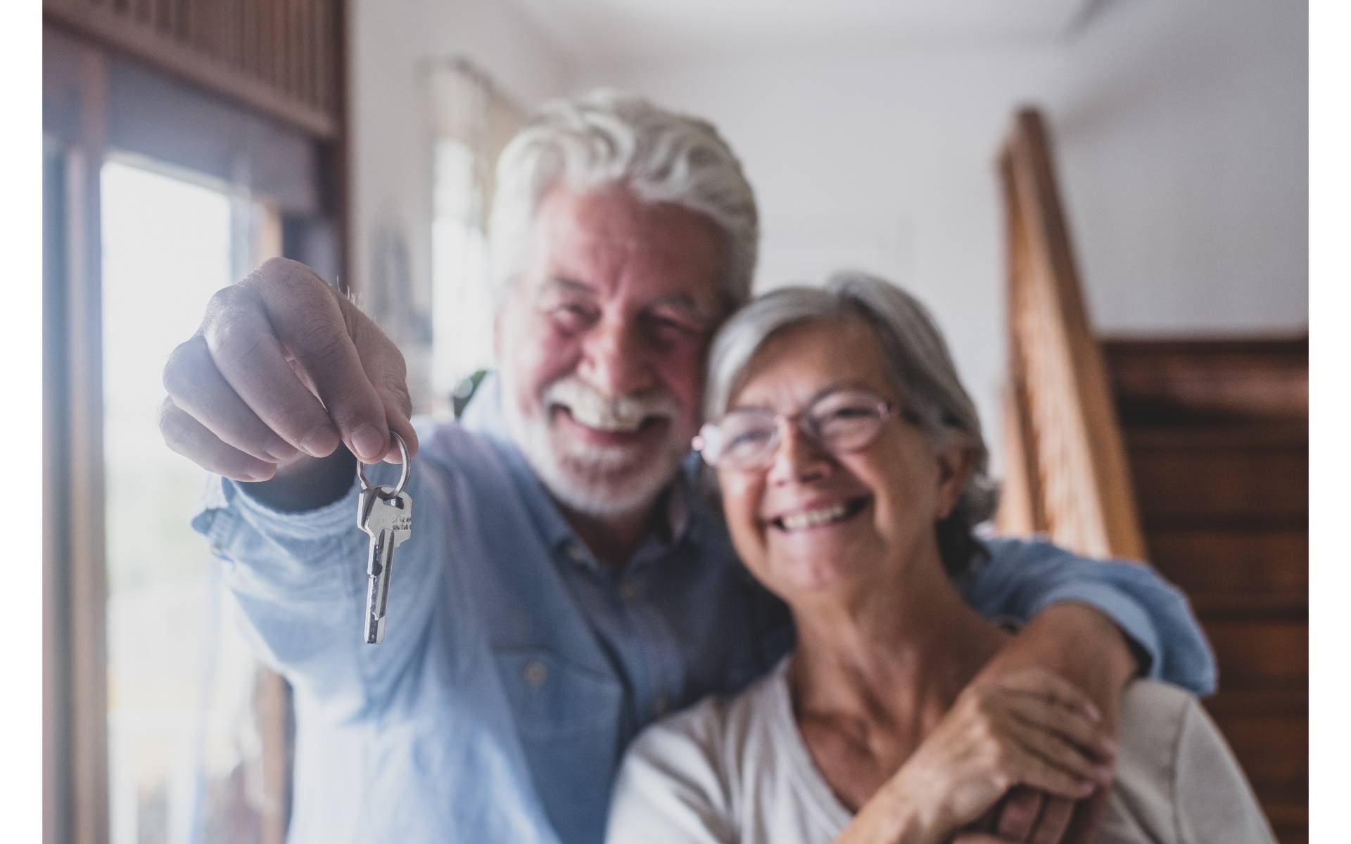 Older couple holding keys. Cover image for article about garage modifications for seniors.