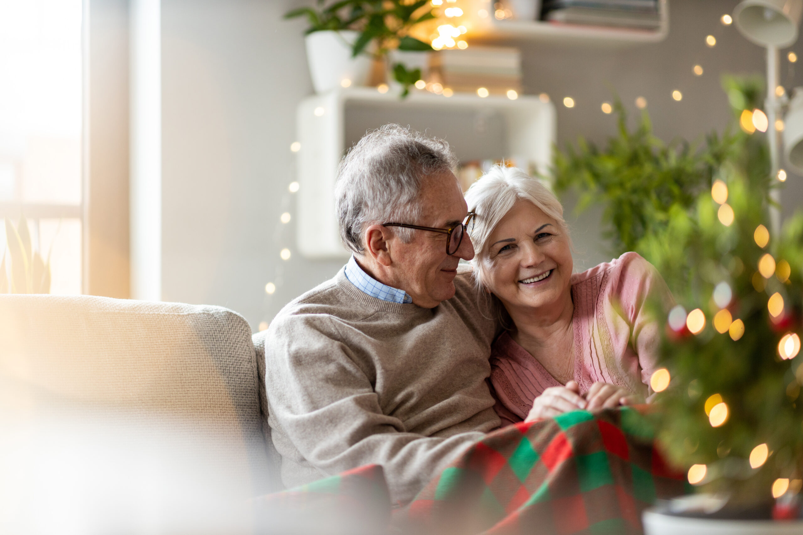 Couple enjoying the holidays after making proper winter preparations for seniors at home